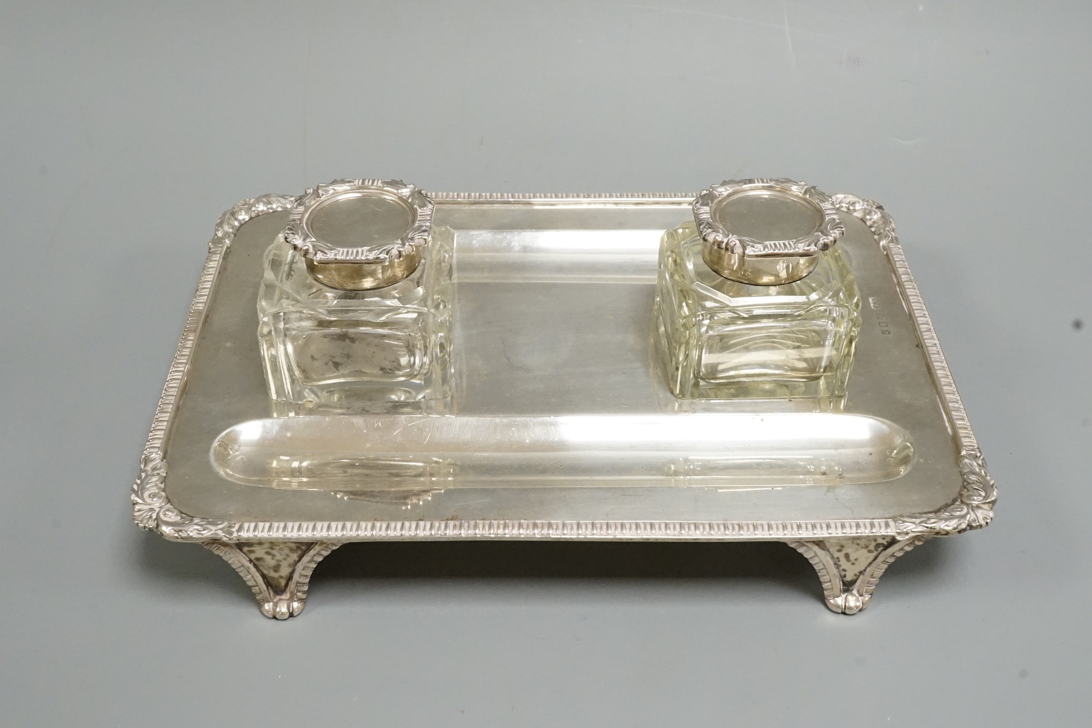 A George V silver inkstand, by Mappin & Webb, with two mounted glass wells, London, 1919, 22.6cm, 12oz.